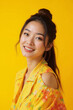 © ADDICTIVE STOCK - Smiling woman in yellow floral shirt with bright yellow background