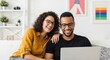 © twilight mist - Happy Diverse Couple Laughing While Using Laptop Together on Sofa in Modern Living Room