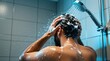 © Viktor - Muscular man washes head, hair under shower at home bathroom. Guy cleans body using soap foam after workout training session. Young male person enjoys cold water flow splashing over shoulders for