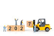 © Sirichai Puangsuwan - Miniature Workers and Forklift Changing Wooden Blocks from 2026 to 2027 New Year Concept