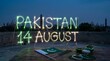 © OlgaNeuroArt - Pakistan 14 August written with sparkler light trails. Independence Day celebration on a rooftop with Pakistani flag and Badshahi Mosque silhouette