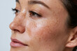 © JoeyMarut - Close up of woman with natural freckled skin and visible pores showing realistic texture and subtle makeup, conveying confidence and skincare authenticity