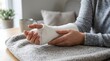 © ENDRA - Woman with bandaged wrist resting on sofa in cozy living room