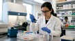 © Felix - Female scientist conducts research in a modern laboratory with pipetting.