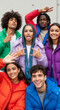 © PhotoArtHub - Group portrait of diverse young adults in colorful puffer jackets, conveying youthful energy and camaraderie, showcasing casual fashion and friendship.
