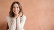 © MSTKHADIZA - Young woman with wavy brown hair smiling brightly with her hands under her chin, standing ad social media download thambnail poster web template event festival 2026 2027 2028