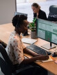 © Milles Team/Stocksy - Woman Working at a Computer Desk With Headset in Call Centre
