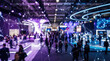 © remake - People gather at a modern technology exhibition inside a large convention hall. Digital network of connected nodes and lines overlays the busy event, symbolizing communication, data connectivity