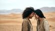 © Rendara Studio - Two affectionate women resting foreheads together among rolling sand dunes in soft light