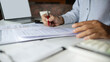 © Lek - close-up shot, businessman work on desk with laptop doing business document and review compay' accounting