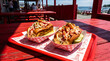 © Creative - Two fresh maine lobster rolls on red picnic table at waterfront restaurant with sandwich waterfront restaurant vacation nautical appetizing delicious