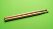 © Анастасия Калинина - Wooden drumsticks resting on a bright green surface