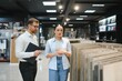 © Serhii - Shop assistant showing ceramic tiles to woman in hardware store