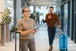 © Serhii - Woman holding passport and ticket traveling in modern airport
