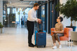 © Serhii - Bellboy helping hotel guest with luggage in lobby