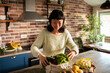 © Davor - Woman unpacking fresh vegetables in home kitchen