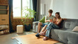 © Lustre Art Group  - Young couple comparing furniture prices on smartphone in new apartment. Concept of mobile shopping, household budgeting and joint decisions in e-commerce, furniture and relocation campaigns.