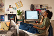 © pressmaster - Teenager celebrating college acceptance while talking on smartphone at bedroom desk, viewing admission email on computer. Ideal for education success, student future, academic marketing