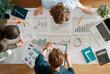 © Konstantin Yuganov - Business Team Analyzing Financial Data and Charts in Modern Office