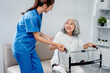 © Freedomz - Caring nurse helps older patient practice walking with a support