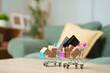 © Joi_studio - Miniature shopping carts with parcel boxes and credit cards on table, online shopping, e-commerce, cashless payment, digital retail, consumer spending, online checkout and delivery
