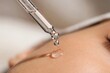 © Dmitrii - Pipette applying serum on woman skin. Facial skincare routine with cosmetic oil. Concept of hormonal balance, beauty treatment and dermatology. Moisturizing treatment and anti-aging care.