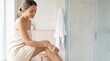 © Islam - Woman practicing dry brushing technique for body skincare routine