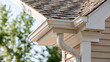 © lnsu - Centered Composition Featuring White Rain Gutter and Downspout Installed along Residential Roof Edge