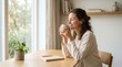 © Ai Joo - Mental Health Wellness Collection – A serene woman sitting at a wooden table holding a warm mug of coffee by a window.