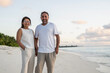 © Cavan Images - Smiling middle aged couple enjoy beach vacation