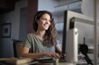 © Cavan Images - Happy young woman smiling while working on a computer at home
