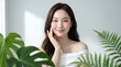 © Best Nayon - Beautiful Asian Woman With Glowing Skin Among Lush Green Tropical Leaves