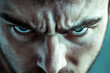 © Artsaba Family - Intense close up of an angry young adult Caucasian man staring with a furrowed brow and scowling expression in moody lighting
