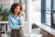 © kucherav - Smiling black businesswoman talking on smartphone standing