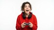 © Pixel Studio - Excited young woman wearing a red hoodie playing a video game with a controller and gaming headphones on her neck