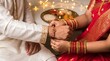 © Jamod Arvind bhai - Indian woman tying rakhi on brother wrist during Raksha Bandhan festival.