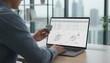© Elvira - Procurement specialist comparing a physical spare part with a digital technical diagram on a laptop at a modern office desk