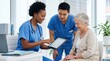 © Visionary - Smiling diverse nurses showing health report on tablet to happy senior woman patient in bright clinic, representing compassionate elderly care, medical consultation, and profess...