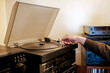 © Digito  Pitoresco - Hand placing needle on vinyl record player turntable