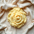 © Pixel-Shot - Creamy mashed potatoes shaped into a decorative rose on a light beige fabric background, top view, food art and culinary presentation