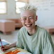 © Andrii Zastrozhnov - Smiling teenager studying with pencils at desk for education background and creative learning banner design in classroom