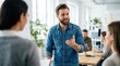 © Masque - A European team leader presents a bright idea to his calm coworkers during a casual office briefing.