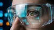 © Masque - Modern engineering and technology visualized through a digital interface reflection on protective glasses and an eye.