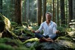© YouraPechkin - Mature Man Meditates Peacefully on Mossy Rock in Forest
