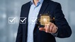 © Muhammad Muawia - Professional businessman in a navy suit selects a glowing digital checkbox on a virtual interface screen