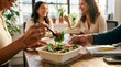 © LA Stock Vision - Office workers eating healthy salads together during a lunch break.