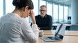 © LA Stock Vision - Two office workers discuss a hiring mistake during a tense disciplinary meeting.
