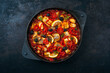 © HLPhoto - Slow cooked fish stew with tomato souce, vegetable and olives in cast iron casserole