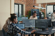© DC Studio - Programmer analyzing compiling code on multiple screens takes off glasses and doing high five hand gesture with colleague developer, software developers celebrating successful coding.