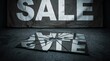 © Joao - A broken sign that reads SALE lies on the ground in front of a larger, slightly tattered SALE banner. This image conveys a sense of finality or perhaps the end of an event.